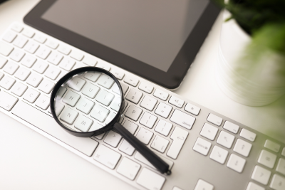 A magnifying glass on a keyboard